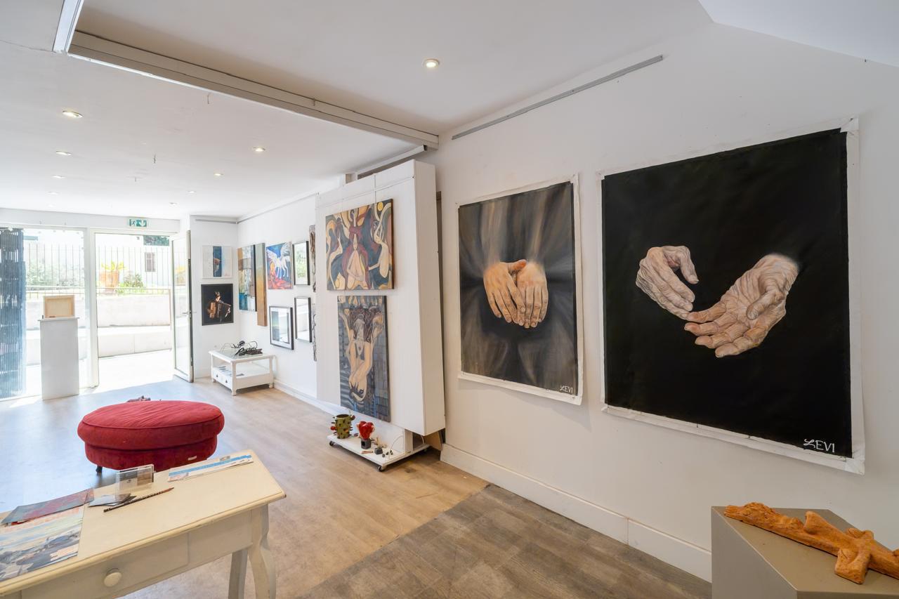 Art Voyage gallery hall hung with contemporary paintings