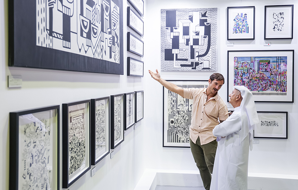 Collectors viewing graphic works at World Art Dubai